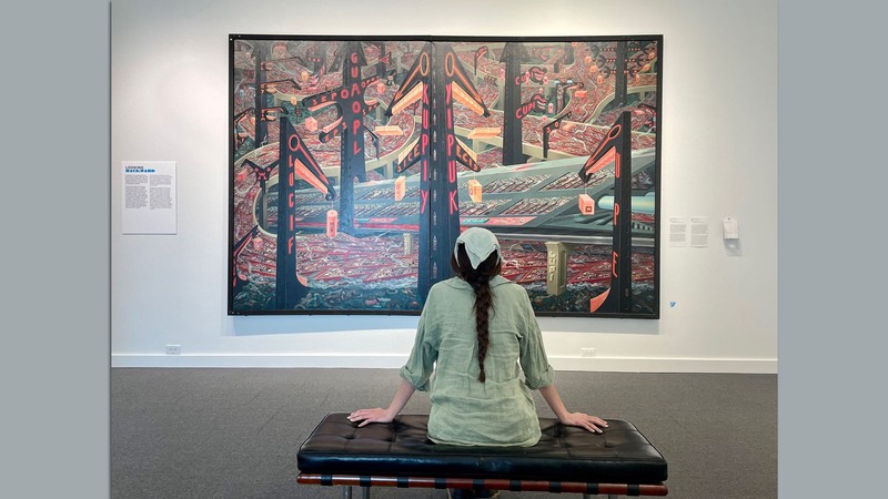 A museum visitor views a work of art.