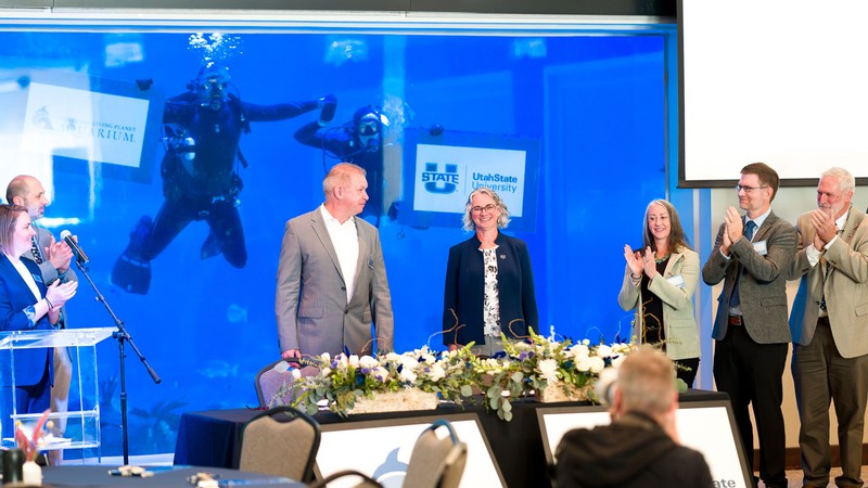 An agreement signing ceremony at an aquarium.