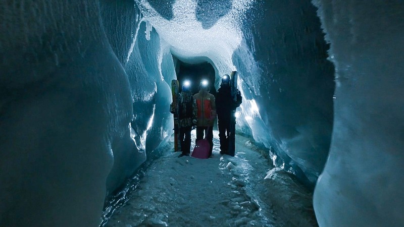 Skiers stand in an ice tunnel in a promotional photo for a film.