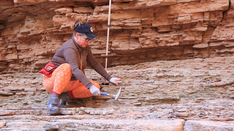 Geologist using a rock hammer in the Grand Canyon.