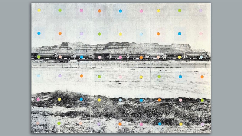 Colorful dots over a weathered photo of a train passing through the desert.