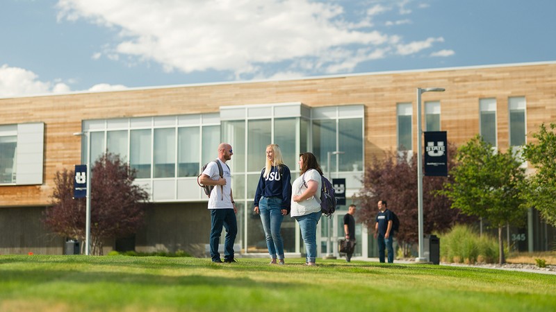 Students stand outside the student center at USU Tooele.
