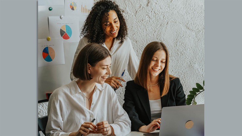 Women working at a laptop.