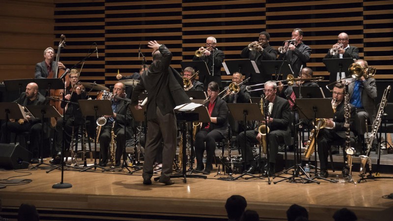 A large jazz ensemble performing onstage.