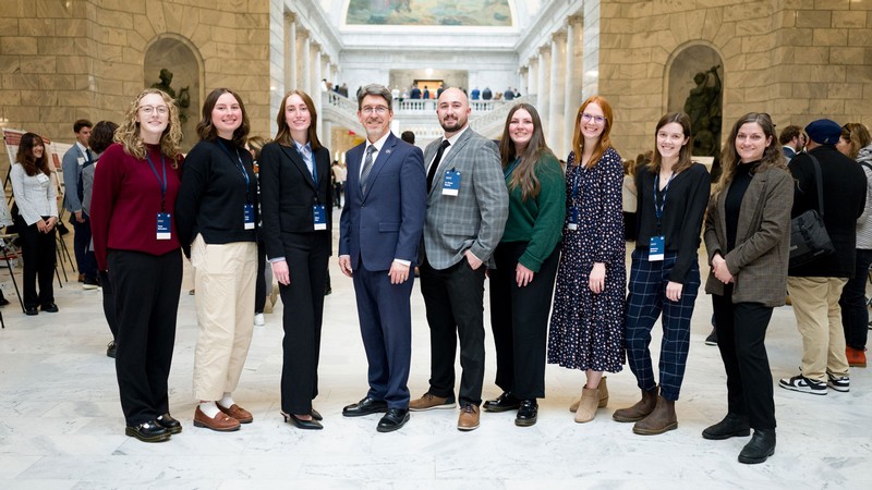 People posing for a photo in the Utah Capitol.