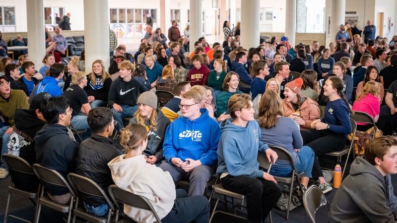 Students speaking with each other at an academic competition.