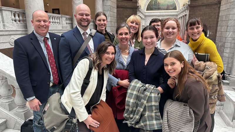 People pose for a photo in the Utah Capitol.