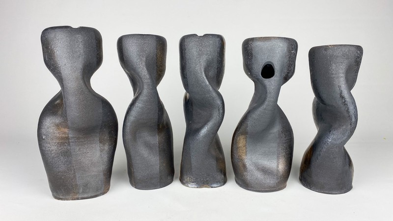 Ceramic sculptures resembling deformed cylinders.