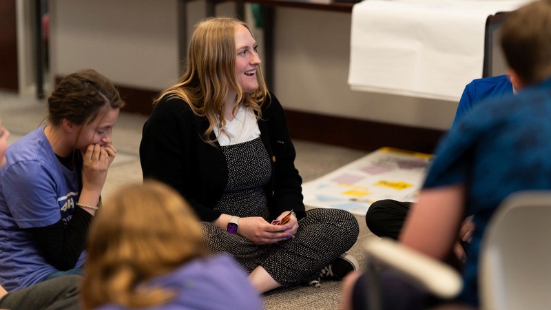 Sarah Weese speaking with people in a classroom.