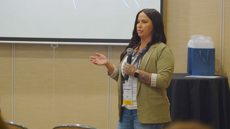 A person speaking at a conference.