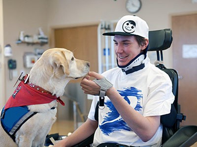 A young man with a therapy dog