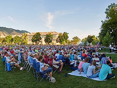 audience member at an outdoor USU Alumni Band concert