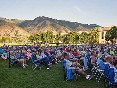 audience members at an outdoor Alumni Band concert at USU