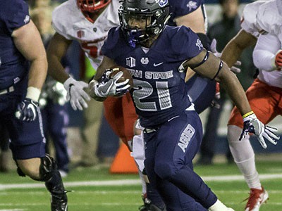 Utah State football players in action