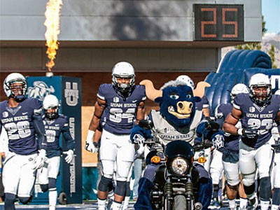 Utah State football players running on to the field