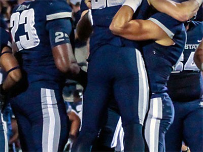 Utah State Univesity football players on the field