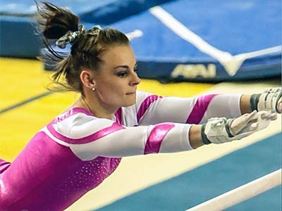 a USU gymnast in action at the bars