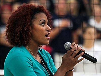 a singer presenting the national anthem at a USU sporting event