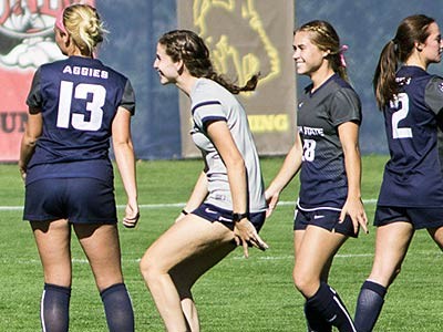 Utah State women's soccer players on the field