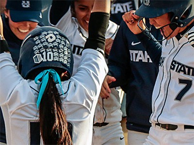 members of USU's women's softball team celebrating