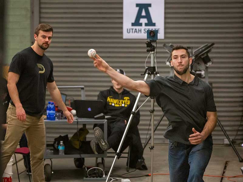 Pitching trainer Dean Jackson throwing a baseball
