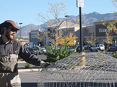 USU scientist with a pond leveler at Logan's south WalMart