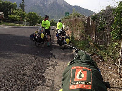 Two Utah Conservation Corps bike crew members at the side of a road