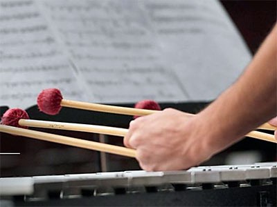 a percussion player at Utah State University holding mallets