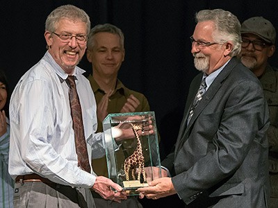 CHaSS professor Mark Damen receiving the college's 'Giraffe Award'