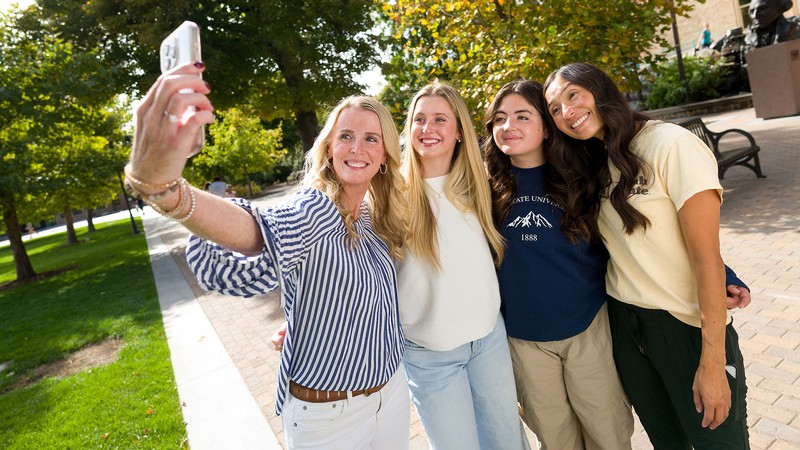 Parents and students taking a selfie on USU's Logan campus.