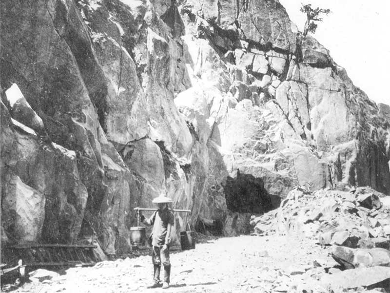 Chinese worker hauling a bucket