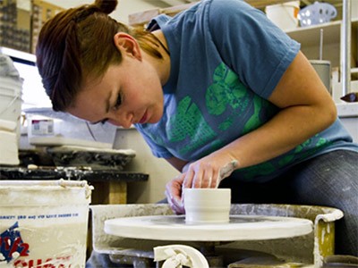a USU student in the ceramics studio