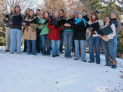 members of USU's Chamber Singers caroling on campus