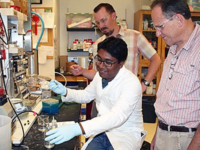 USU biochemists perform lab tasks