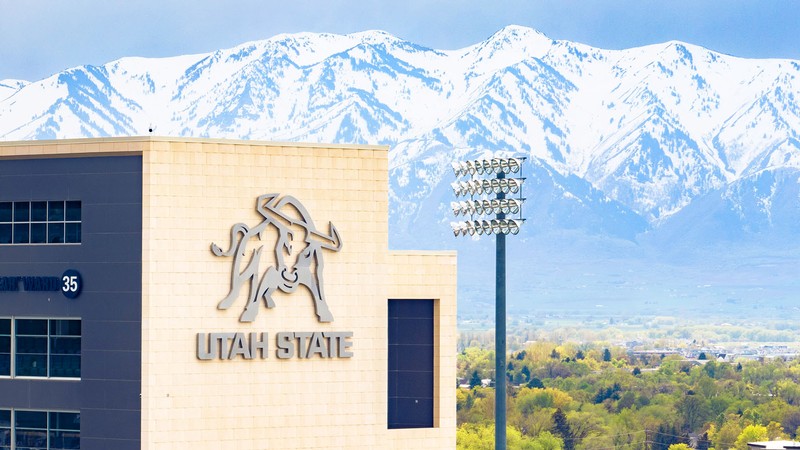An aerial shot of Maverick Stadium and the snowy mountains behind