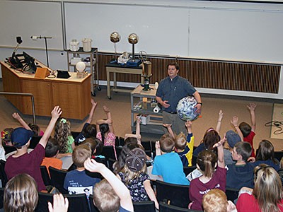 participants and James Coburn at a USU physics demonstration show