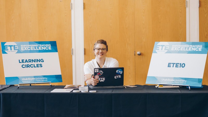 USU employee sits at the learning Circles registration desk.