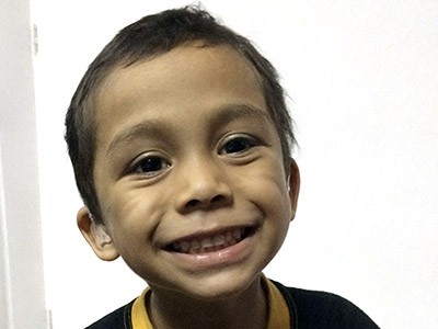a young boy from El Salvador and a USU hEARt program client