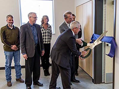 USU President Stan Albrecht cuts the ribbon to open a new classroom at the Equine Education Center