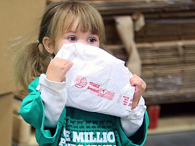 a young girl helps sort meat for the 4-H Meat Donation Program