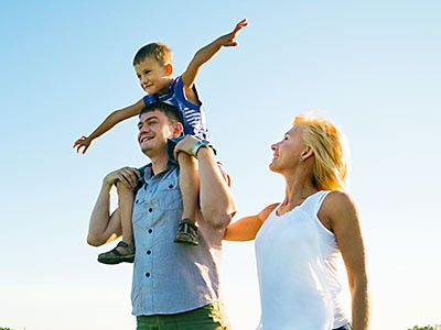 a photograph of a family walking in a field