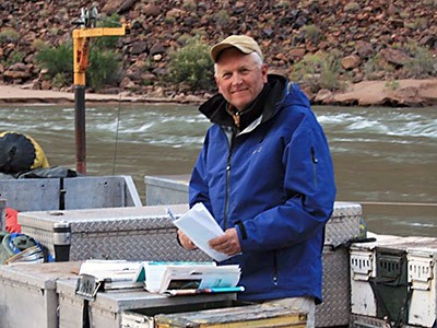 USU professor Jack Schmidt on a boat