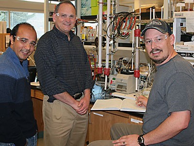 USU biochemists Nimesh Khadka, Lance Seefeldt, Derek Harris in a lab