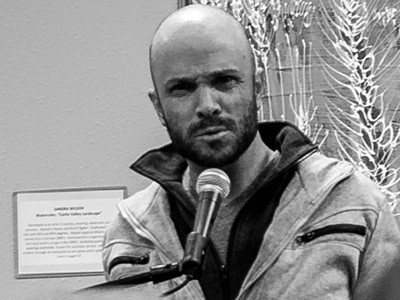 poet Darren Edwards reading at a Helicon West event