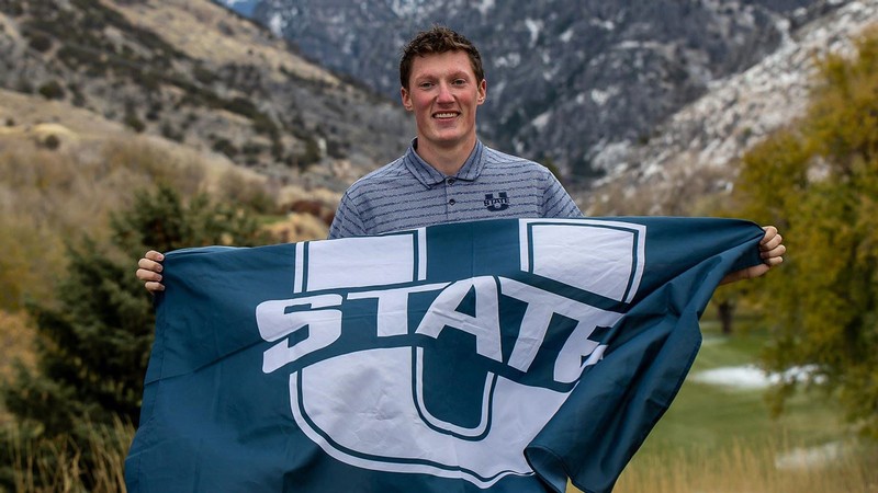 Andy Hess holding a U State flag.