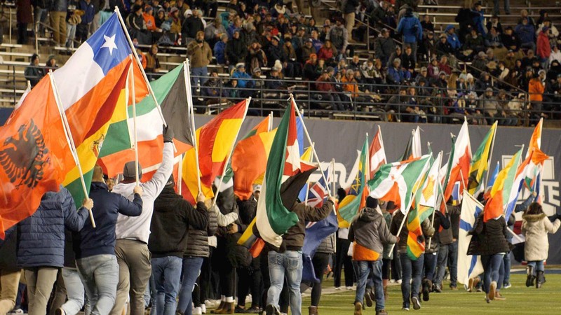 International flags fly at USU's Maverik Stadium.