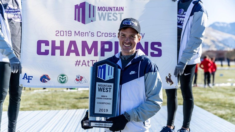 James Withers holds 2019 Mountain West Championship trophy.