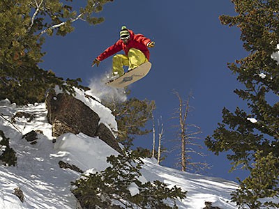 Jeremy Jensen executing a jump while powdersurfing