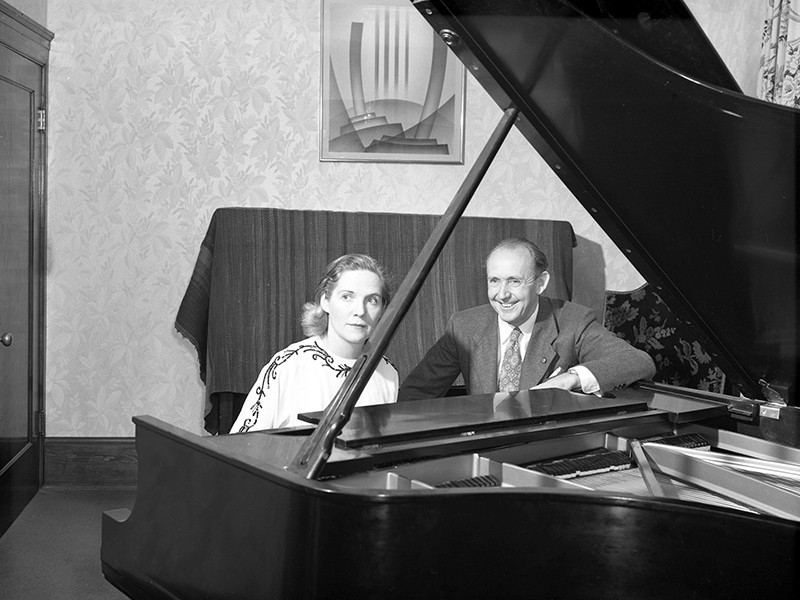 man and woman at piano in an archive photo