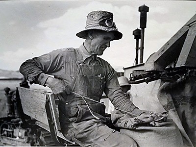 USU Museum exhibit, photograph of a Mormon farmer bagging wheat